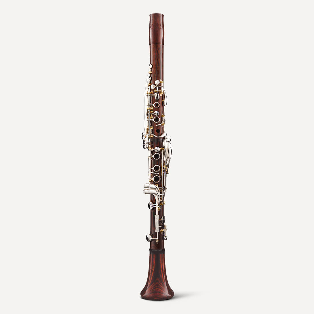 The Backun Lumière A Clarinet, featuring elegant silver keys, stands upright against a plain white background.