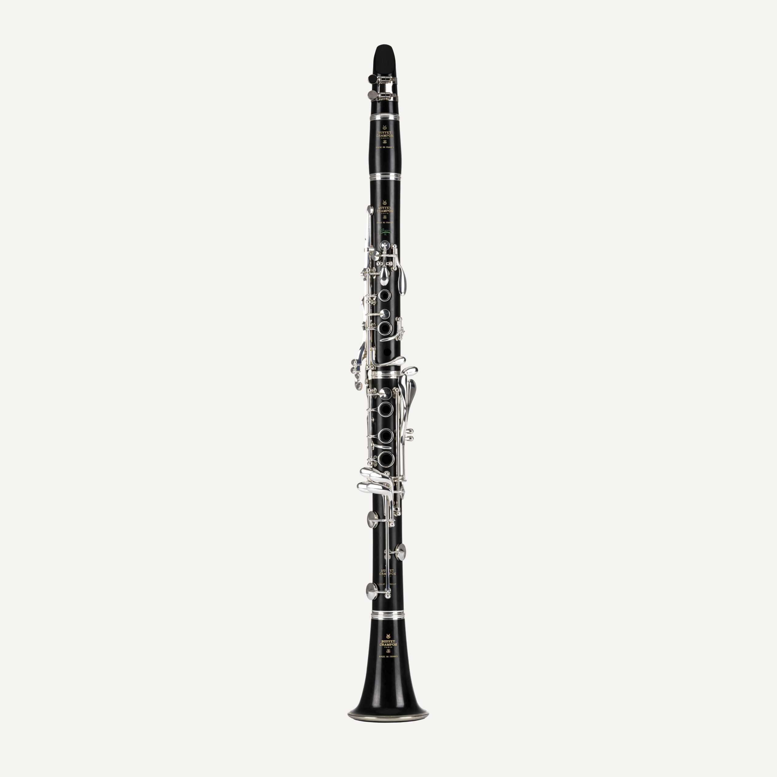 The Buffet R13 Bb Greenline Clarinet, featuring a black body and silver keys, stands upright against a plain white background.
